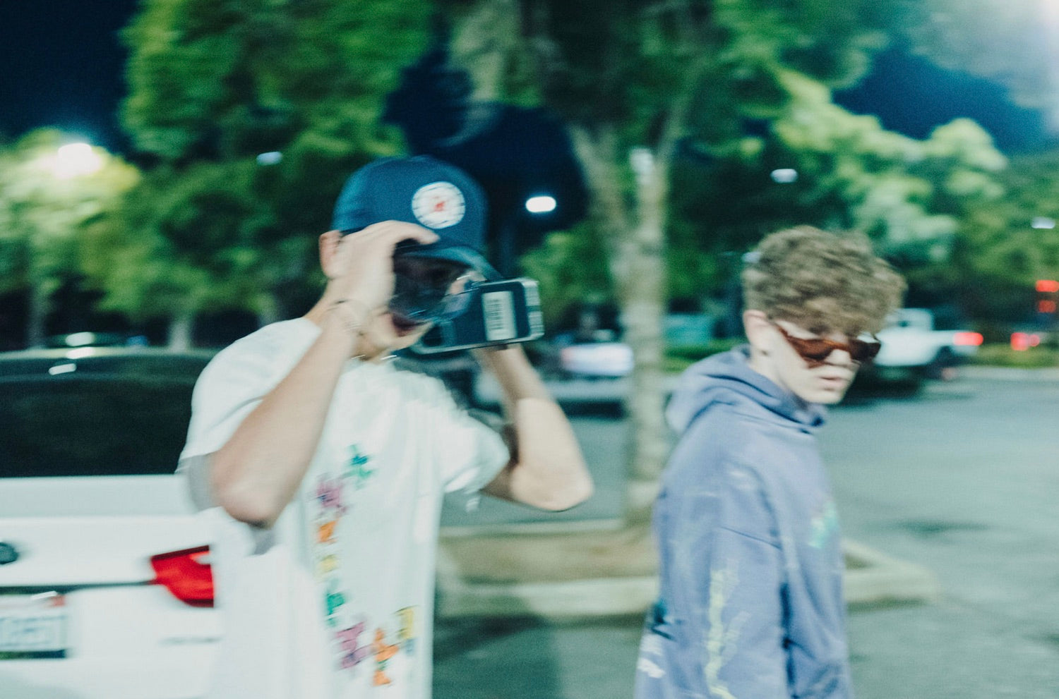 11 Out of the Ordinary Hangout Ideas. Two guys hanging out at the parking lot.