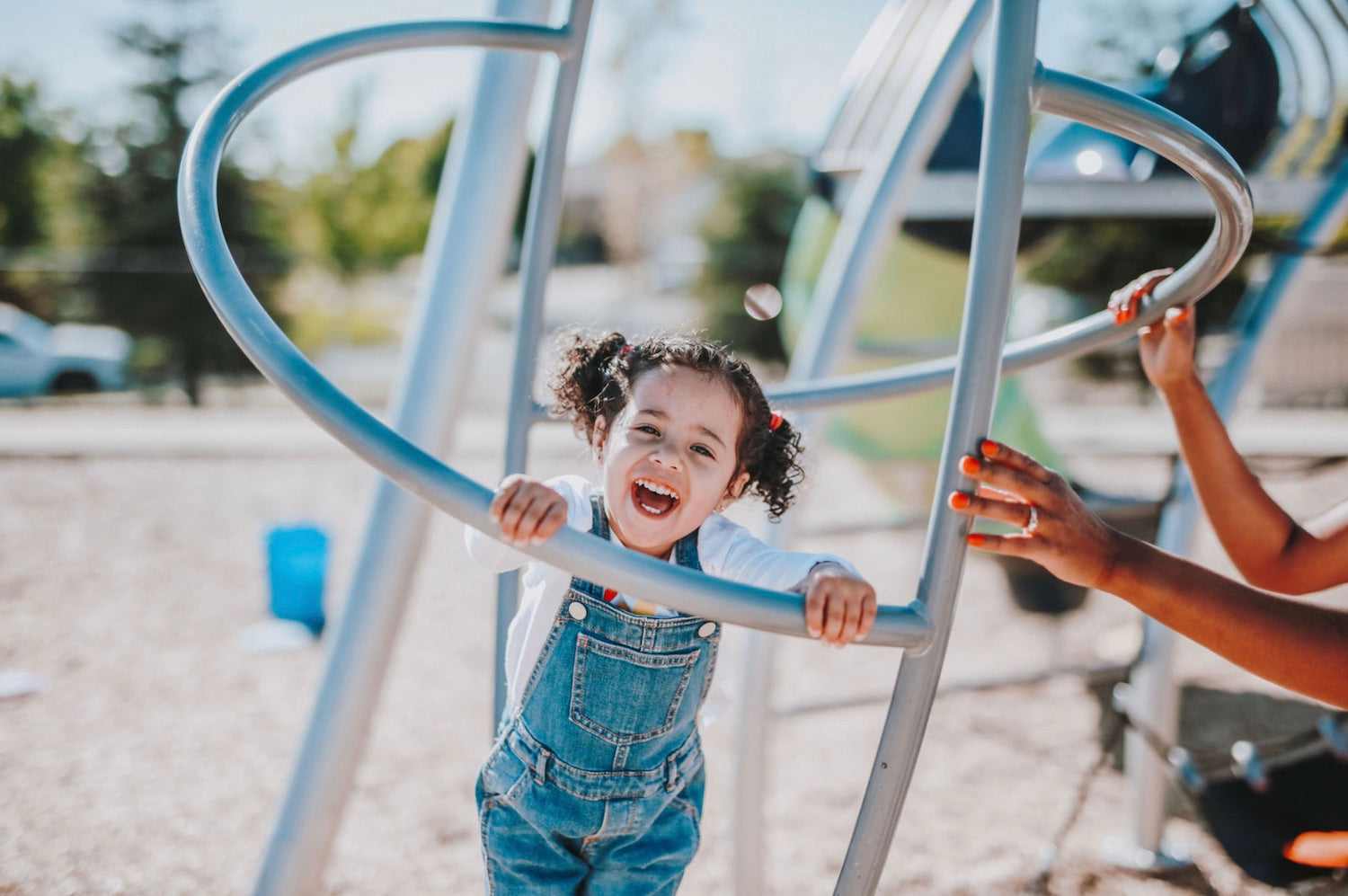 How to Plan The Best After School Activities for Kids. Little girl with a huge smile on her face as she plays in a playground.
