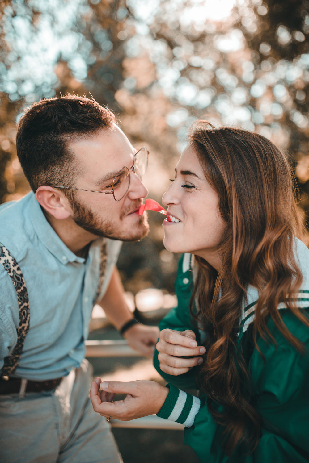 Relationship Building: 7 Things You've Probably Never Thought to Do. Couple splitting a candy with their faces inches away from each other.