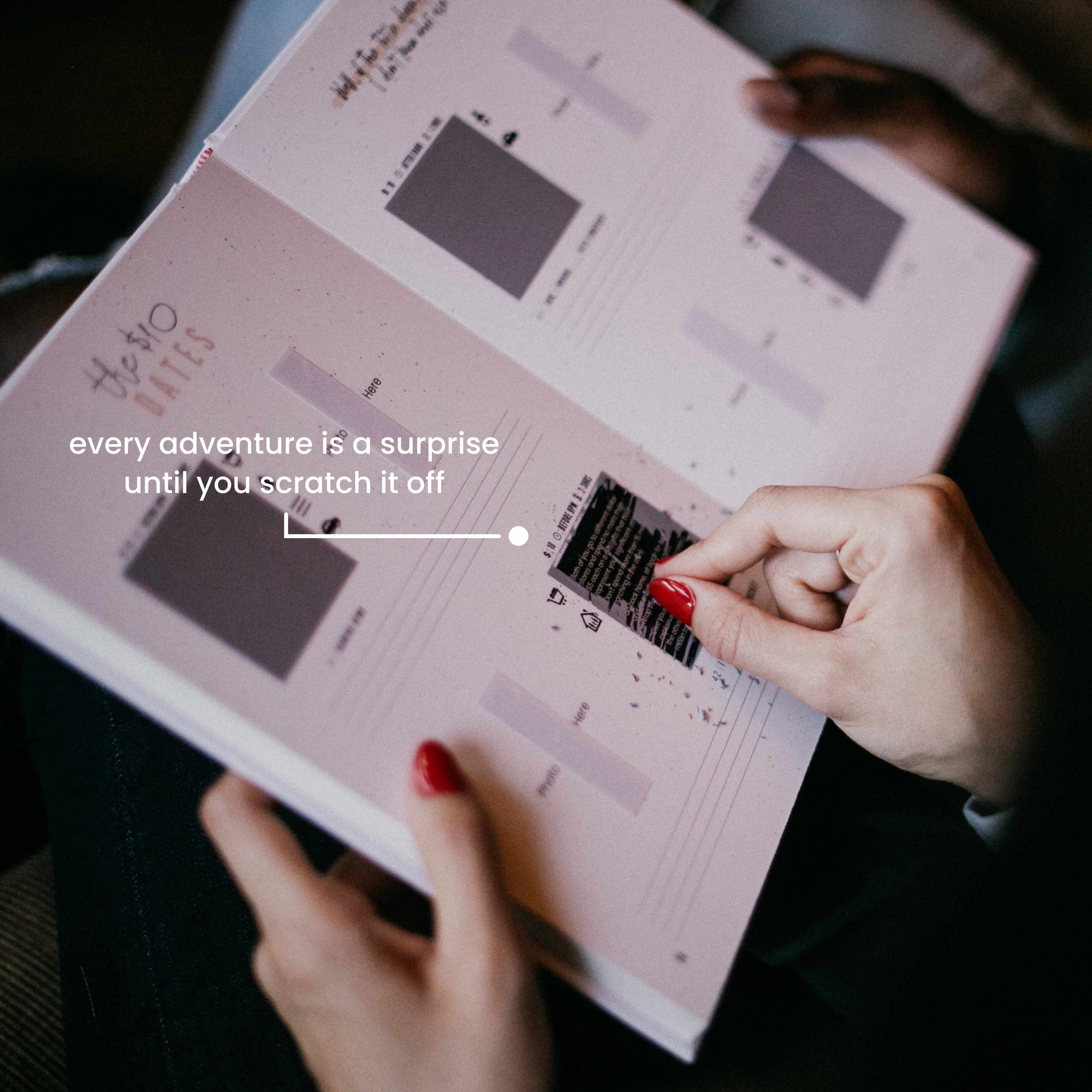 Hand scratching off a mystery date idea in the Couples Edition book, revealing a spontaneous and fun game for two.