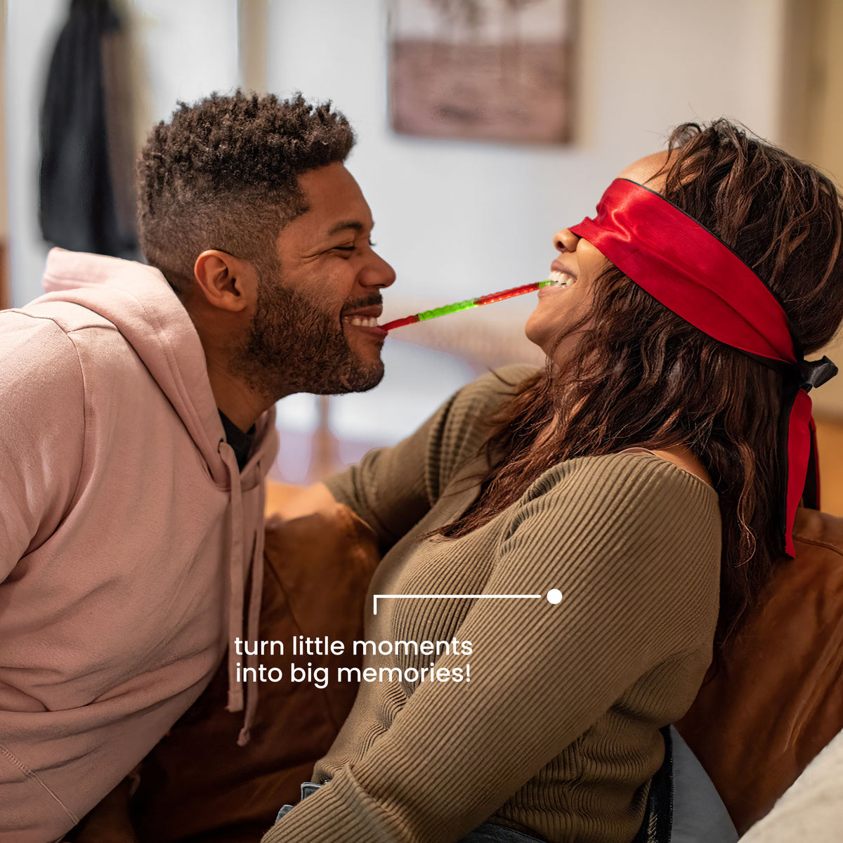 Couple laughing during a playful blindfolded Mini Date at home